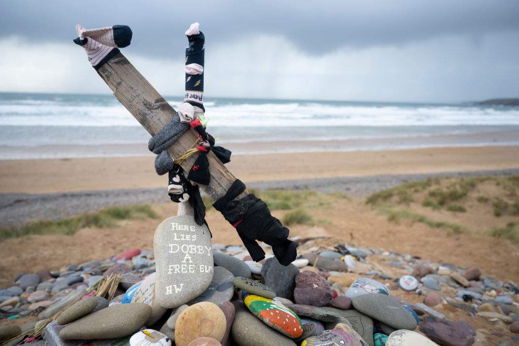 A close-up of painted stones left at a memorial in tribute to Dobby, a fictional house elf from the Harry Potter fantasy novels and films, at Freshwater West beach on November 6, 2022 in Castlemartin, United Kingdom.