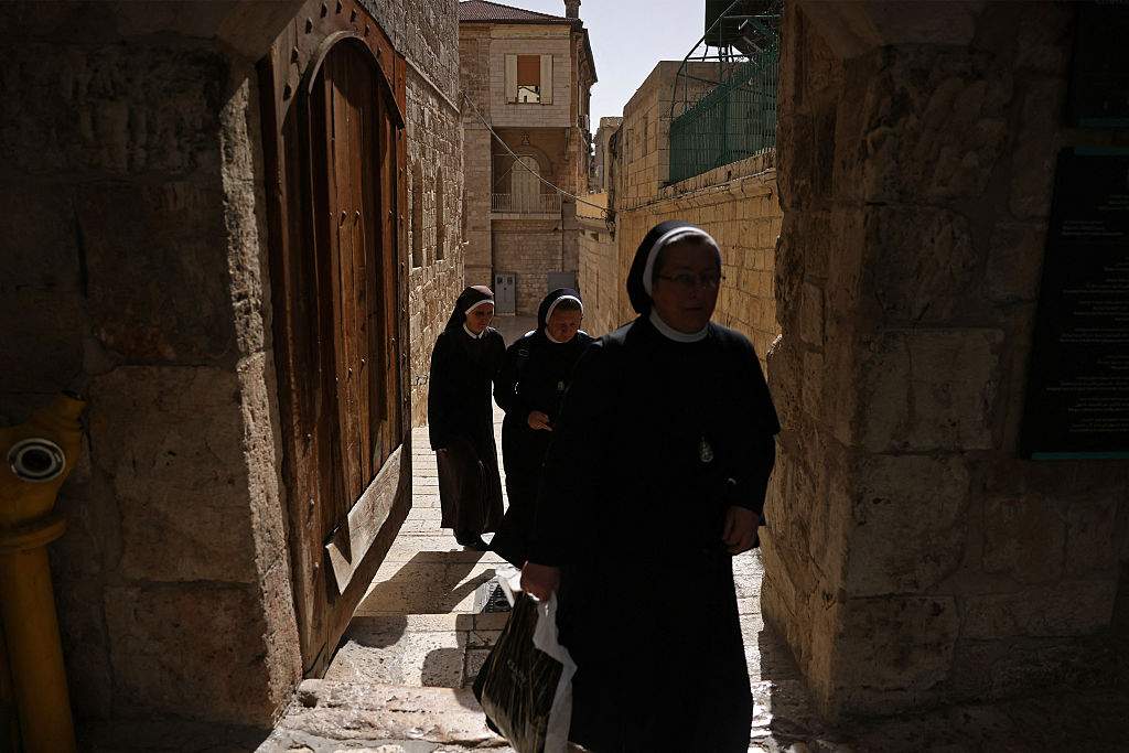 Nuns walk on their way to the Church of the Holy Sepulchre in the old city of Jerusalem on May 3, 2026.