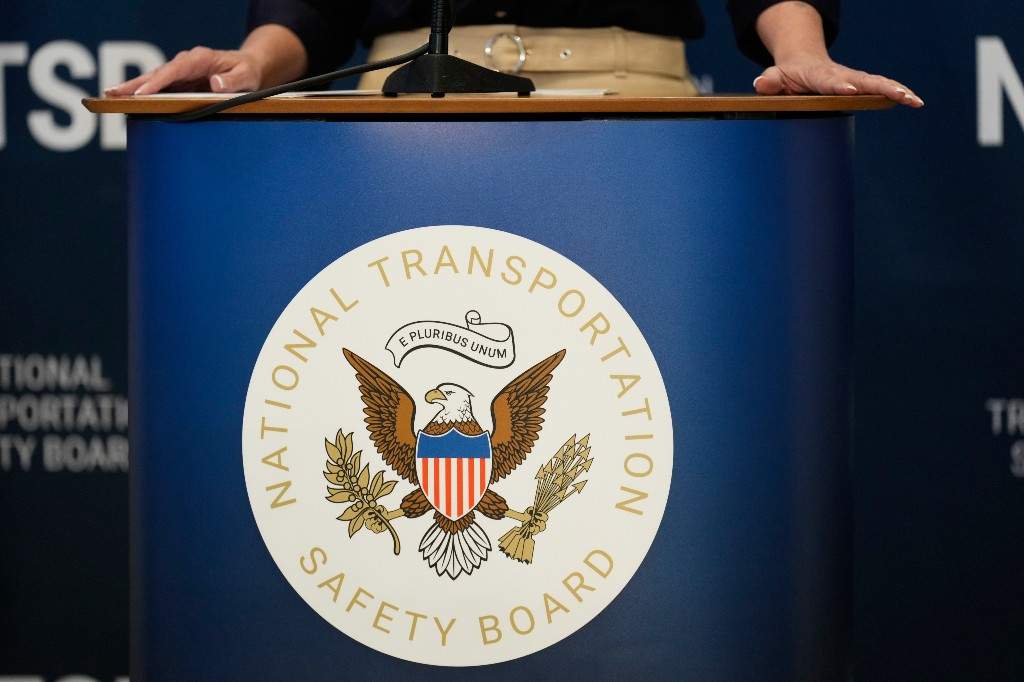 NY LaGuardia Crash Signage for the National Transportation Safety Board is displayed on the podium.