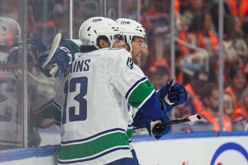 Cotter, Canucks outlast Oilers 6-5 in overtime