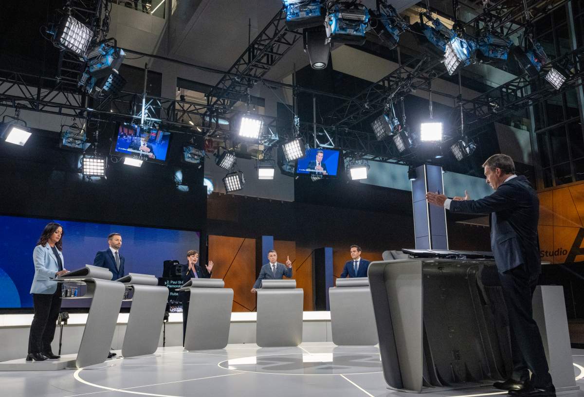 Debate moderator Patrice Roy, right, puts a question to party leaders during a leaders debate in Montreal on Wednesday, Sept. 23, 2026. Quebec votes in a provincial election on Oct. 5, 2026.