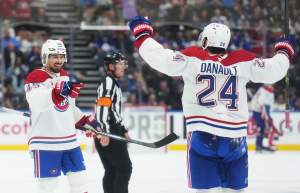 Montreal Canadiens' Alexandre Carrier (45) celebrates his goal against the Toronto Maple Leafs with Phillip Danault (24) during third period NHL hockey action in Toronto on Tuesday, Sept. 29, 2026.