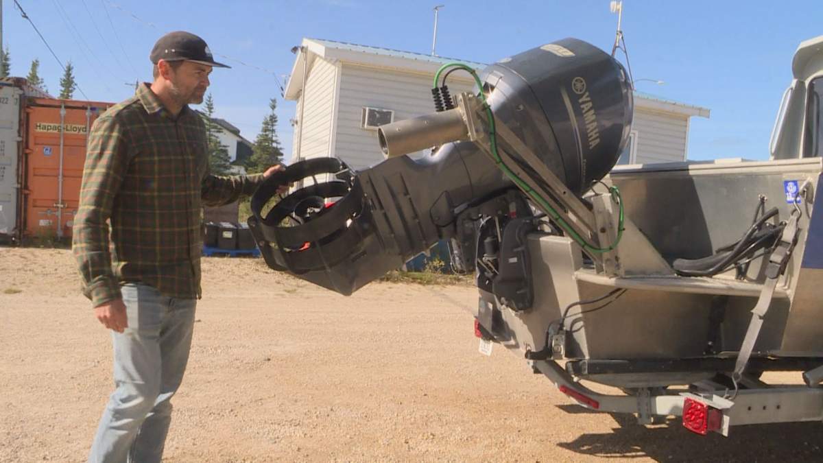 Kieran McIver with the beluga boat on dry land after another season of capturing images of Churchill's beluga migration.