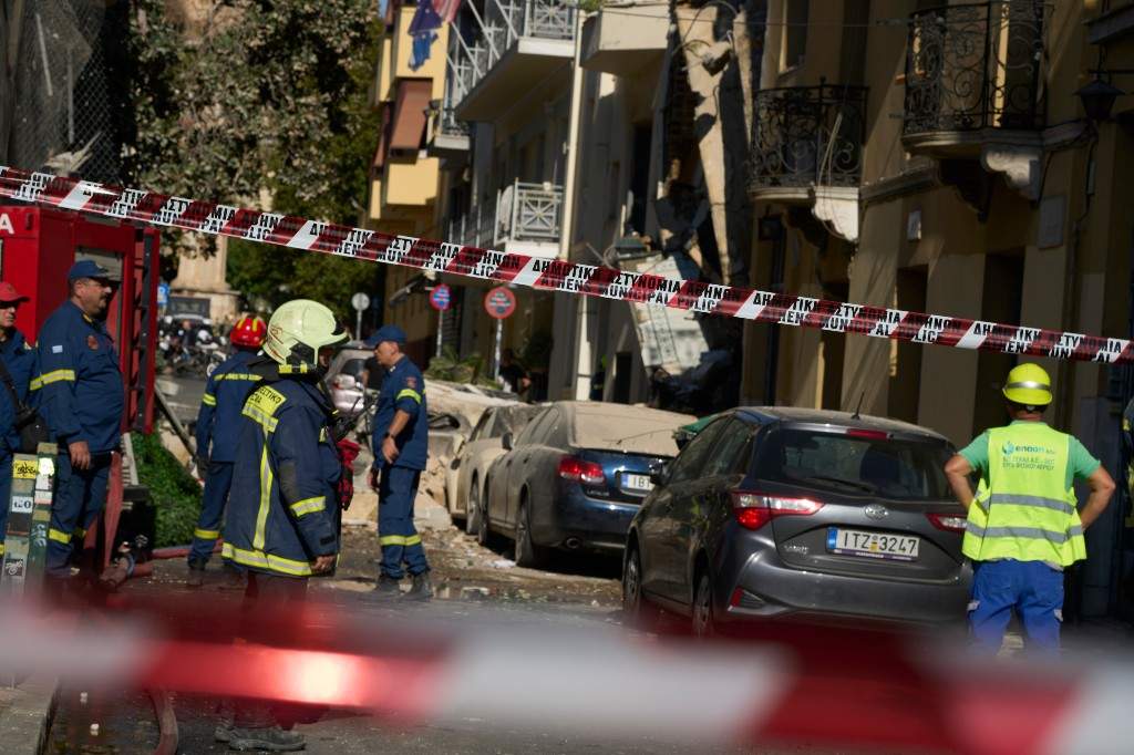 Firefighters work at the scene following a powerful blast that caused a building to collapse and injured at least two people in Athens' Plaka district, Friday, Sept. 25, 2026.