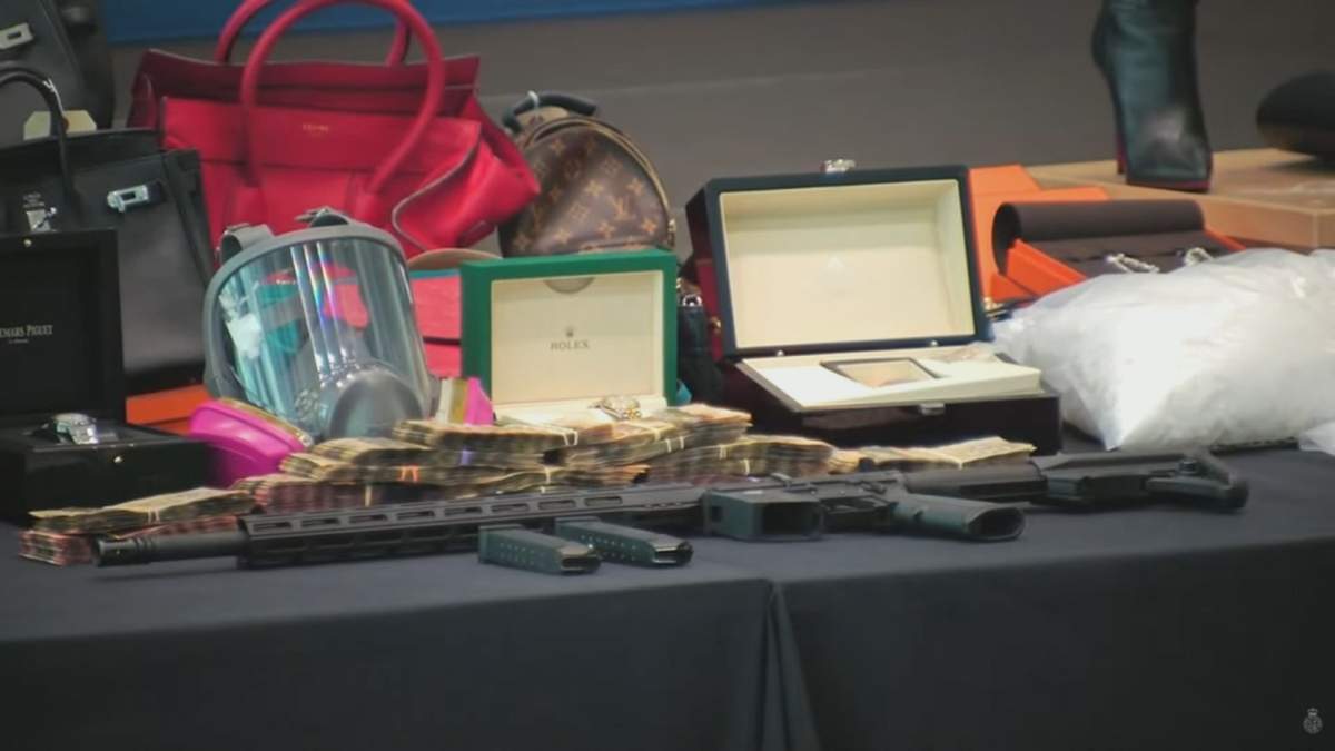An illegal fierarm, currency and drugs are on display on Sept. 22 after being seized in a months-long investigation.