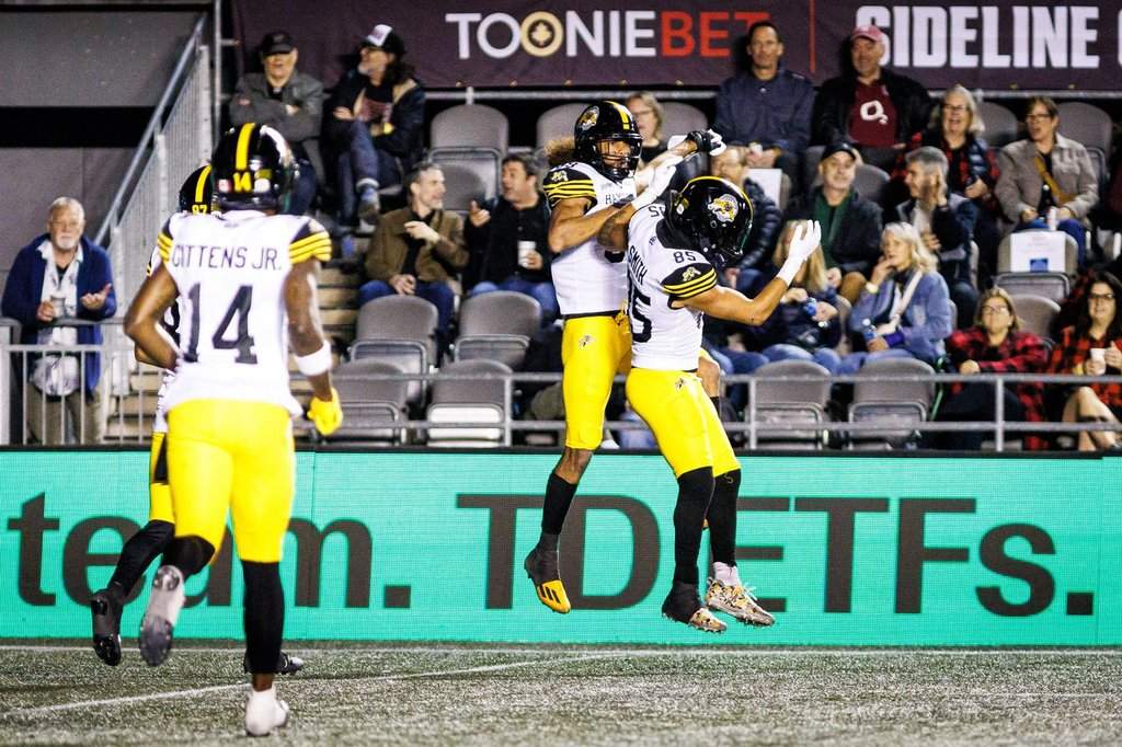 Hamilton Tiger-Cats' wide receiver Kenny Lawler (centre) celebrates his touchdown against the Ottawa Redblacks with wide receiver Kiondre Smith (85) during second half CFL action in Ottawa, on Friday, Oct. 2, 2026. THE CANADIAN PRESS/Keito Newman.