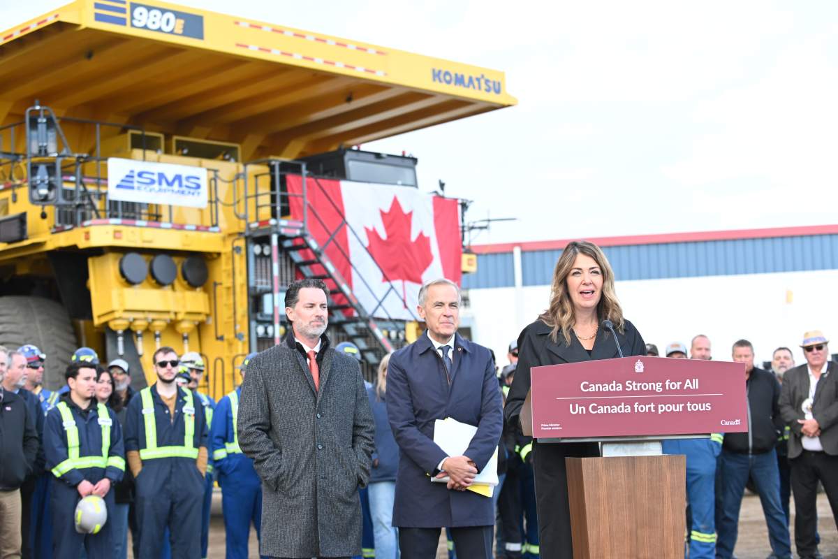 Alberta Premier Danielle Smith speaks as Prime Minister Mark Carney and Scott Burrows, CEO of the Pembina Pipeline Corp listen in Fort McMurray, Alta. on Thursday Oct 1, 2026.