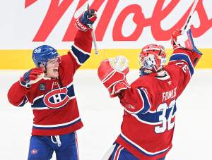 Montreal Canadiens goaltender Jacob Fowler (32) celebrates with teammate Cole Caufield (13) following the team's shootout win over the Detroit Red Wings in an NHL hockey game in Montreal on Saturday, Oct. 10, 2026.