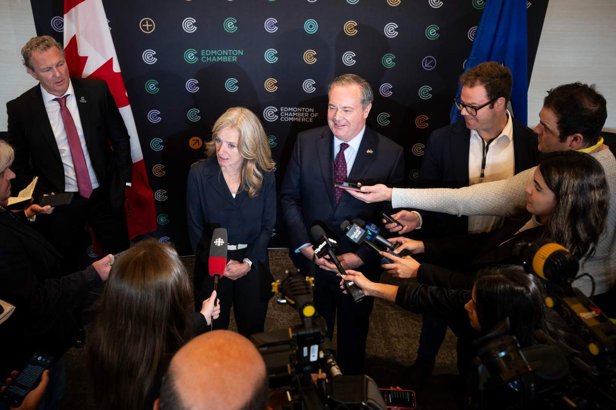 Former Alberta premiers Rachel Notley, left, and Jason Kenney discuss their assessment of the possible economic cost of Alberta’s referendum at an Edmonton Chamber luncheon, in Edmonton, on Tuesday, Oct. 13, 2026.