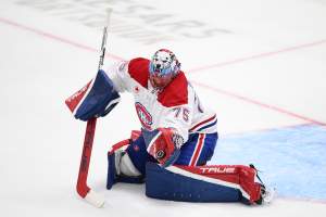 Montreal Canadiens goaltender Jakub Dobes (75) deflects the puck during the third period of an NHL hockey game against the Washington Capitals, Wednesday, Oct. 14, 2026, in Washington. (AP Photo/Nick Wass)