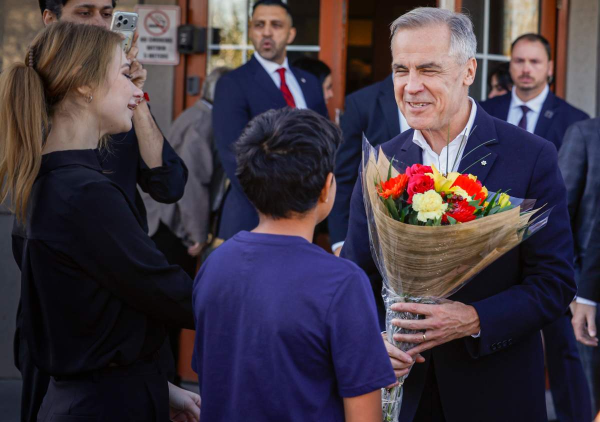 Prime Minister Mark Carney, right, meets with supporters at a restaurant in Calgary, Thursday, Oct. 15, 2026.