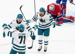 San Jose Sharks' Tyler Toffoli (73) celebrates his goal over Montreal Canadiens goaltender Jakub Dobes (75) with teammates Macklin Celebrini (71) and Kiefer Sherwood (44) during third period NHL hockey action in Montreal on Tuesday, Oct. 20, 2026.