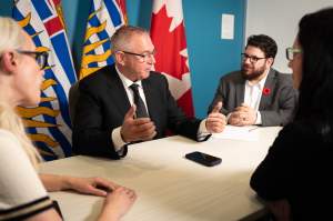 B.C.'s premier-designate shared this photo of he and his team speaking with Prime Minister Mark Carney.