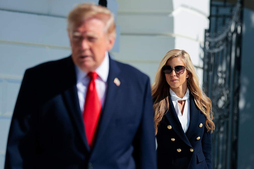 White House Press Secretary Katie Zacharia (R) joins U.S. President Donald Trump as he departs on the South Lawn of the White House on October 13, 2026 in Washington, DC.