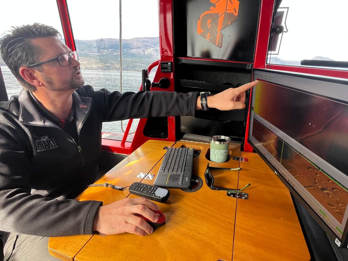 Manuel Maendel points out an anomaly on the sonar screen. It could be something, but without a visual confirmation, there's no way to know for sure what's beneath the surface.