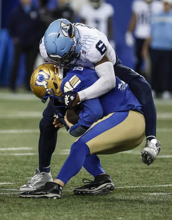 Winnipeg Blue Bombers quarterback Dru Brown (4) gets sacked by Toronto Argonauts' Adarius Pickett (6) in Winnipeg on Friday, Sept. 25, 2026. THE CANADIAN PRESS/John Woods.