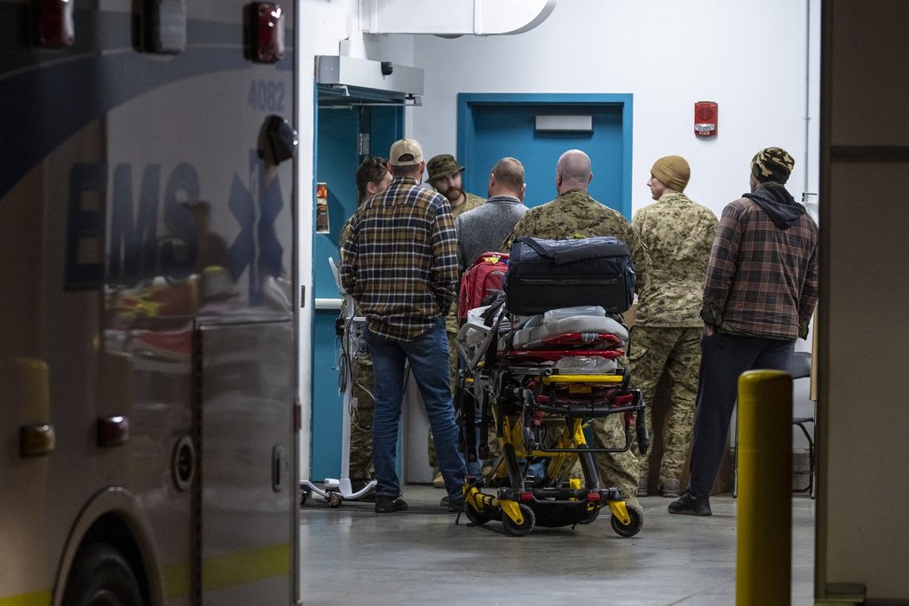 Emergency crews and military personnel at the Wainwright Health Centre as injured military members are treated after a fire at CFB Wainwright, outside of Wainwright, Alta., on Saturday, Oct. 17, 2026.